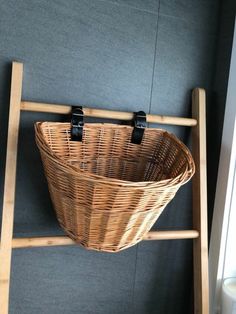 a wooden ladder with a basket hanging on it