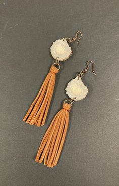 Handmade Antler and Leather Tassel Dangle Earrings in Light Brown Make a statement with these bold handmade antler and purple tassel dangle earrings.  The antler is sourced from naturally shed horn.  The leather tassels are soft with a matte-finish.  These earrings feature copper and copper tone accents.  - Ear Wire Closure - Length : 4.5" Not including ear wire closure.  Measurement is an approximation from ring attached to the top of antler to end of tassel. Leather Tassel, Ear Wire, Antlers, Horn, Light Brown, Jewelry Earrings Dangle, Tassels, Dangle Drop Earrings, Shed