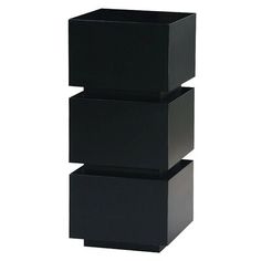 three black boxes stacked on top of each other in the shape of cubes,