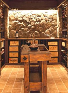 a wine cellar with stone walls and wooden cabinets