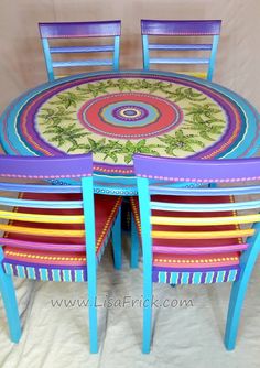 the table and chairs are all painted in different colors