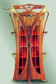 an ornate wooden display cabinet with glass doors and shelves in the middle, on a green background