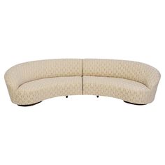 a curved couch with an upholstered back