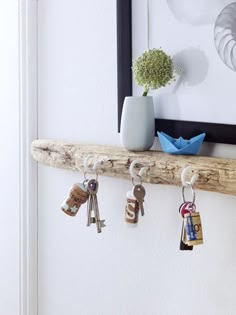 a wooden shelf with keys hanging from it's sides and the words interest written in red