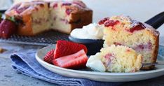 a piece of cake on a plate with strawberries