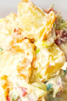 a close up view of a potato salad with dressing in the middle and on top