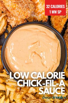 fried chicken with dipping sauce in a black bowl surrounded by french fries on the side