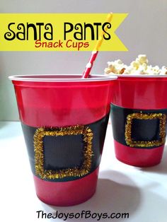 two red cups with gold tinsel on them