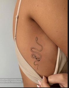 a woman with a snake tattoo on her back