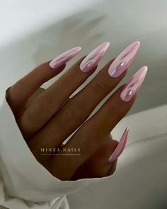 a woman's hand with pink and white nail polishes on her nails, in front of a white background