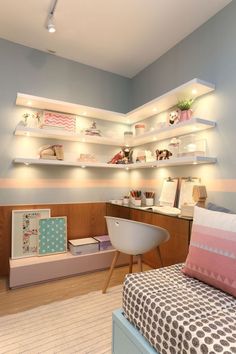 a child's bedroom with shelves above the bed