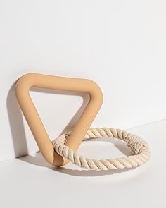 two pieces of rope sitting on top of a white surface next to each other,