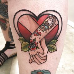 two hands holding each other in front of a heart with flowers and leaves on it