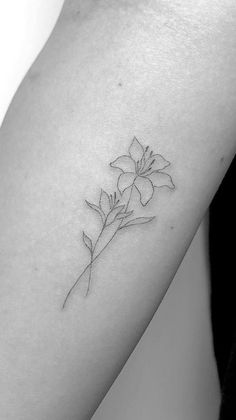 a single flower tattoo on the arm