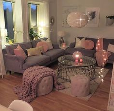 a living room filled with furniture and candles on top of it's coffee table