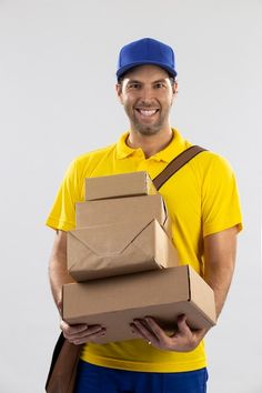 a delivery man holding several boxes and smiling at the camera stock photo 547982