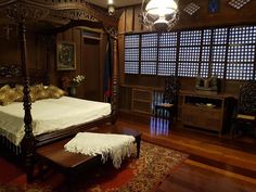 a large bed sitting on top of a wooden floor