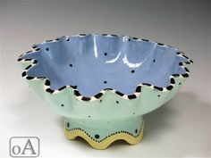 a blue and white bowl with black dots on it