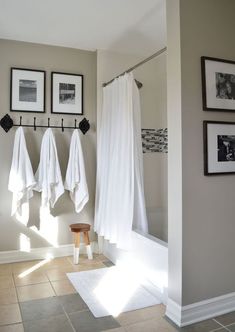 a bathroom with white towels hanging on the wall