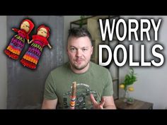 a man is holding two crochet dolls in front of him with the words worry dolls above them