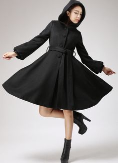 A wardrobe must-have , This Black wool coat features a Hood and Lantern Sleeve, Finished with a fit and flare style and a self-tie waist belt, This winter jacket pairs perfectly over your favorite fall dresses for added warmth.DETAIL* Wool blend fabric, and Polyester Lining* Long lantern sleeves * button fastening thro Black Wool Coat Women, Black Wool Coat, Wool Coat Women, Winter Outerwear, Coat Winter, Belted Coat, Cashmere Coat, Lantern Sleeve, Hooded Coat