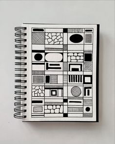 a notebook with black and white designs on it