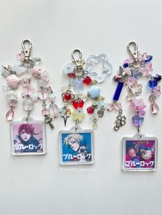 four key chains with charms attached to them