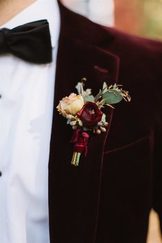 a man in a tuxedo with a boutonniere on his lapel