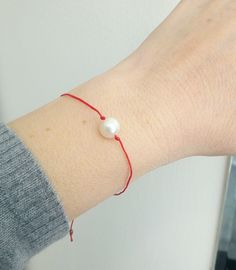 Red string bracelet with freshwater pearl, Adjustable red bracelet with single pearl, Minimalist jewelry, Everyday bracelet Beautiful minimalist bracelet with red string and freshwater pearl All pieces of jewelry are beautifully packaged, ready to be gifted. JEWELRY CARE: Please take care of your jewelry do not wear in the shower, swimming pool, or to bed. Keep away from harsh chemicals and cleaners. It is always best to put on your jewelry on after applying lotions, hair sprays and make-up. Rem Red Pearl Bracelets As A Gift, Red Pearl Bracelets For Gifts, Red Pearl Bracelets For Gift, Red Pearl Bracelet As A Gift, Red Pearl Bracelet As Gift, Red Pearl Bracelet Gift, Red Bracelet, Single Pearl, Everyday Bracelet