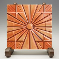 an artisticly designed piece of art made out of copper tint and wooden wheels