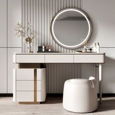 a white vanity with a round mirror and stool in front of it, next to a wall