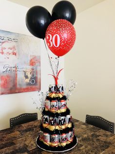 a birthday cake with balloons on top