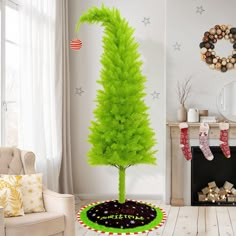 a green christmas tree sitting in the middle of a living room next to a fire place