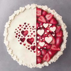 two cakes with hearts on them and one has strawberries in the shape of hearts