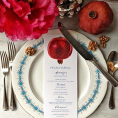 a place setting with an apple on the menu card and silverware next to it