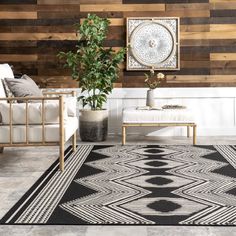 a black and white area rug in front of a wooden wall