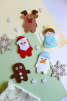 some felt animals and snowflakes on a table