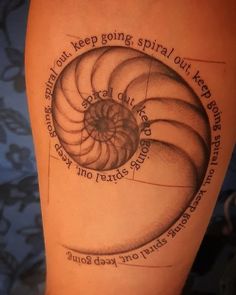 a woman's leg with a tattoo on it that says, keep going spiral out