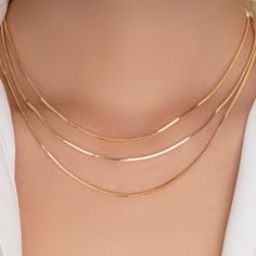 Material: gold plated brass Length: 14" + 2" extension IMPORTED Gold Snake Chain Choker With Adjustable Chain, Gold Charm Necklaces With Delicate Snake Chain, Gold Snake Chain Choker With Delicate Details, Gold Charm Necklace With Delicate Snake Chain, Gold Delicate Snake Chain Choker, Gold Snake Chain Choker Necklace, Gold Snake Chain Clavicle Choker, Gold Clavicle Snake Chain Choker, Tarnish Resistant Gold Layered Necklace