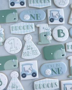 decorated cookies are arranged in the shape of baby's first birthdays and numbers