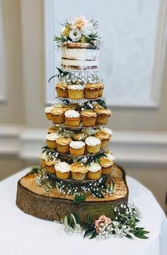 a wedding cake with cupcakes stacked on top