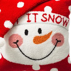 a red and white snowman pillow with it's snow written on the front