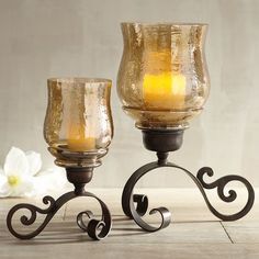 two glass candles are sitting next to each other