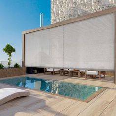 an outdoor swimming pool with blinds on the side and wooden flooring next to it