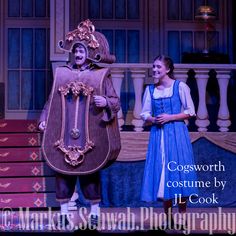 two people dressed in costumes on stage with the caption cogsworth costume by it cook