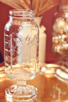 a glass jar sitting on top of a wooden table