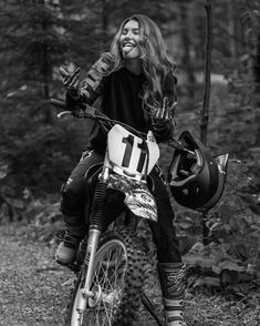 a woman sitting on top of a dirt bike