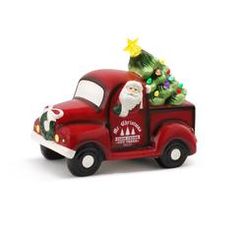 a red truck with a christmas tree on the back