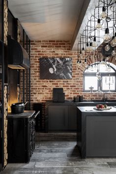 a kitchen with brick walls and black cabinets