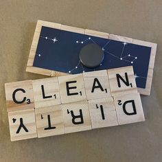 two scrabble tiles with the words clean, written in black and white on them